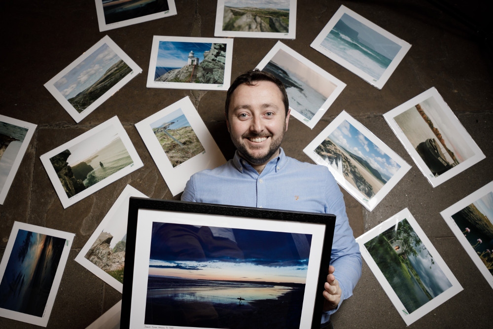 Man surrounded by photographs.